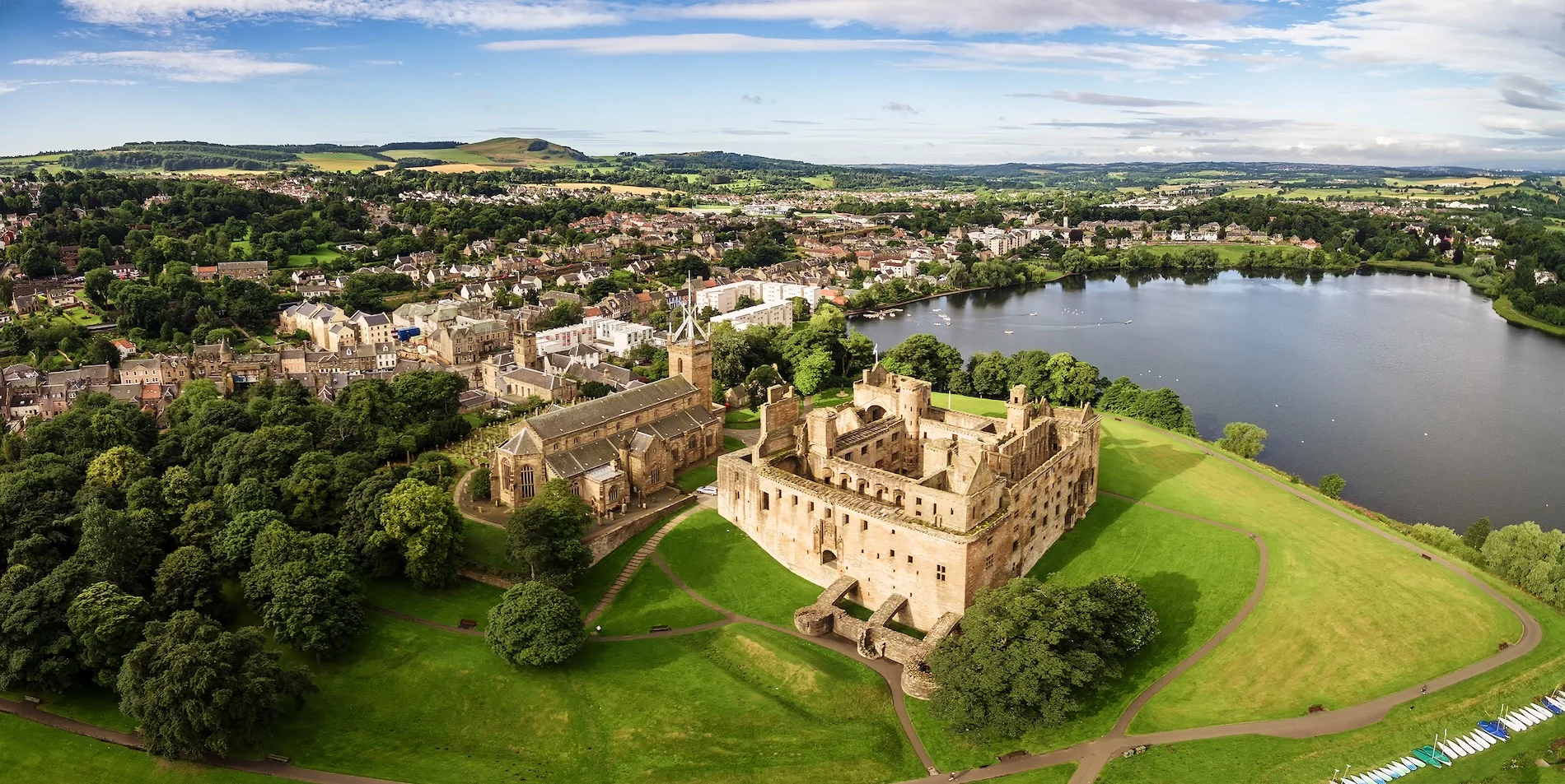 Aerial view of Linlithgow Palace and town beside river in Scotland