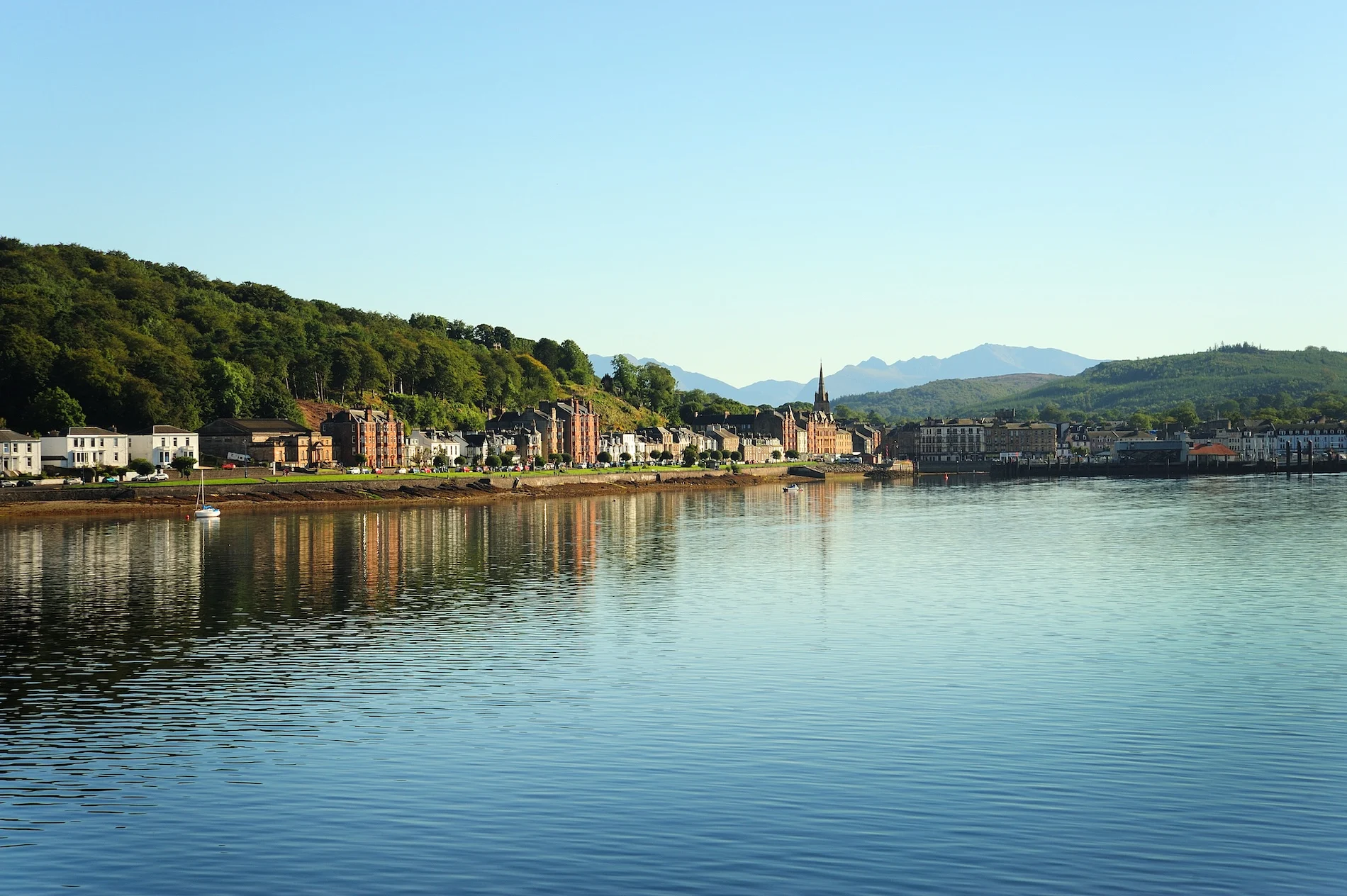 Scenic riverside town with historic architecture and mountains in Scotland