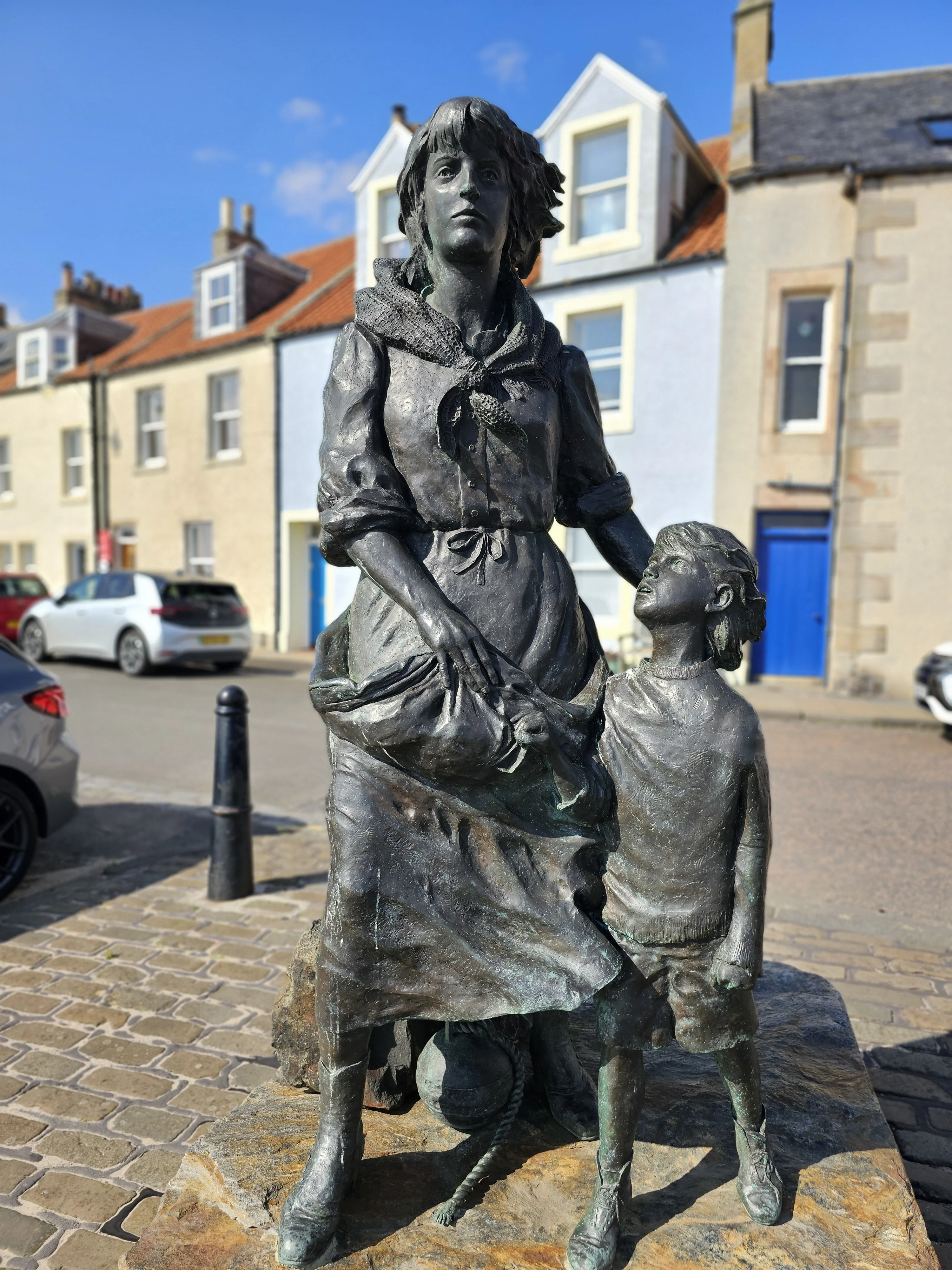 Bronze statue of woman and child in Scottish village street