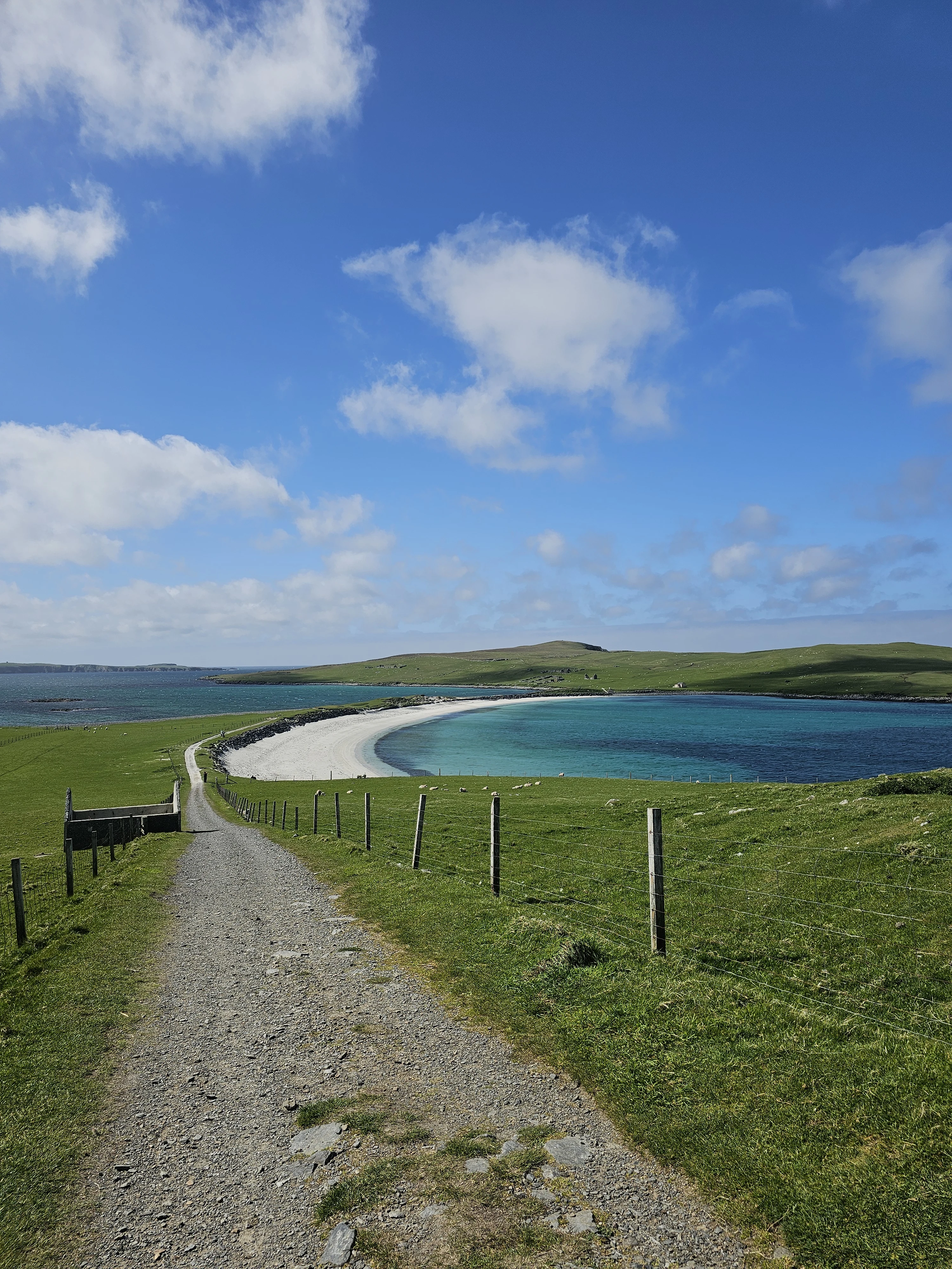 Rural path leading to white sand beach with turquoise water, Scottish Highlands