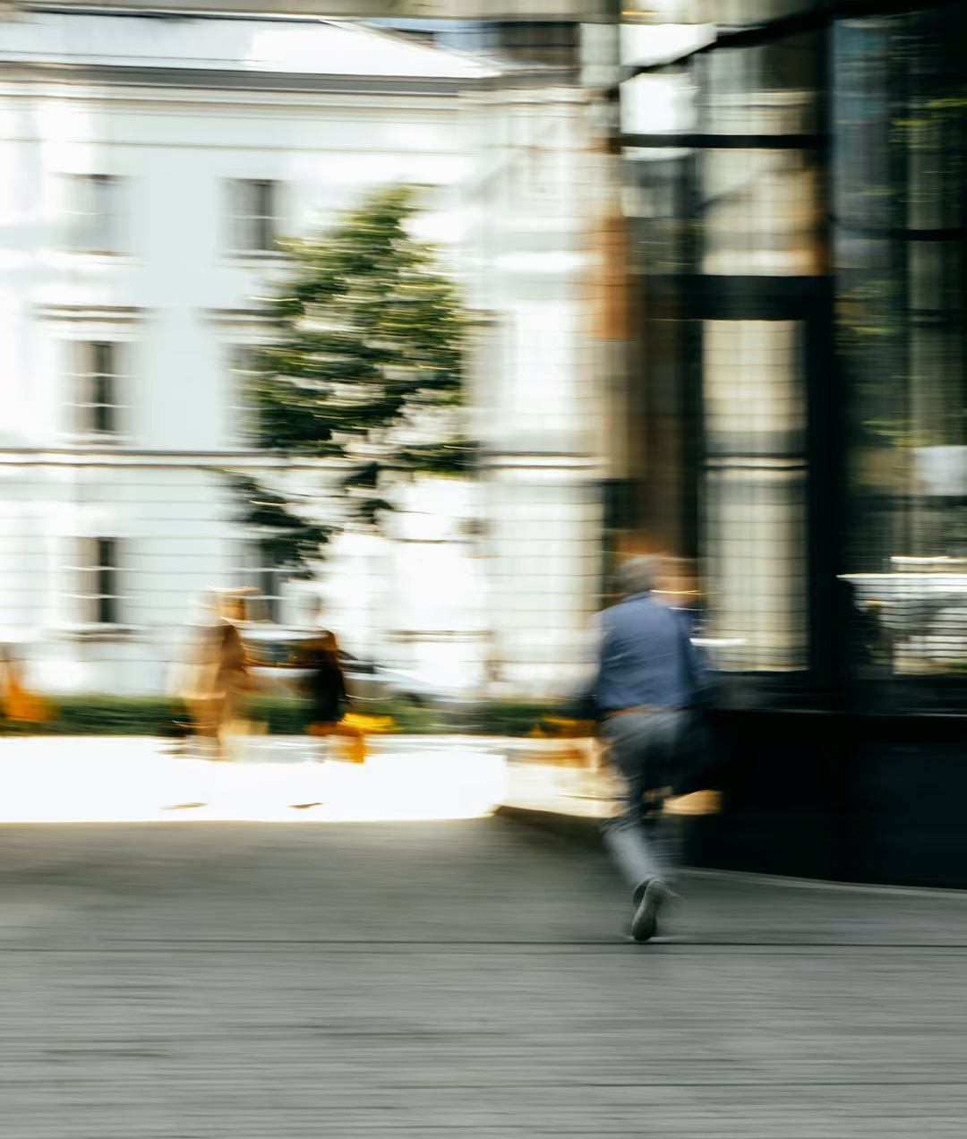 blurred photo man walking through city