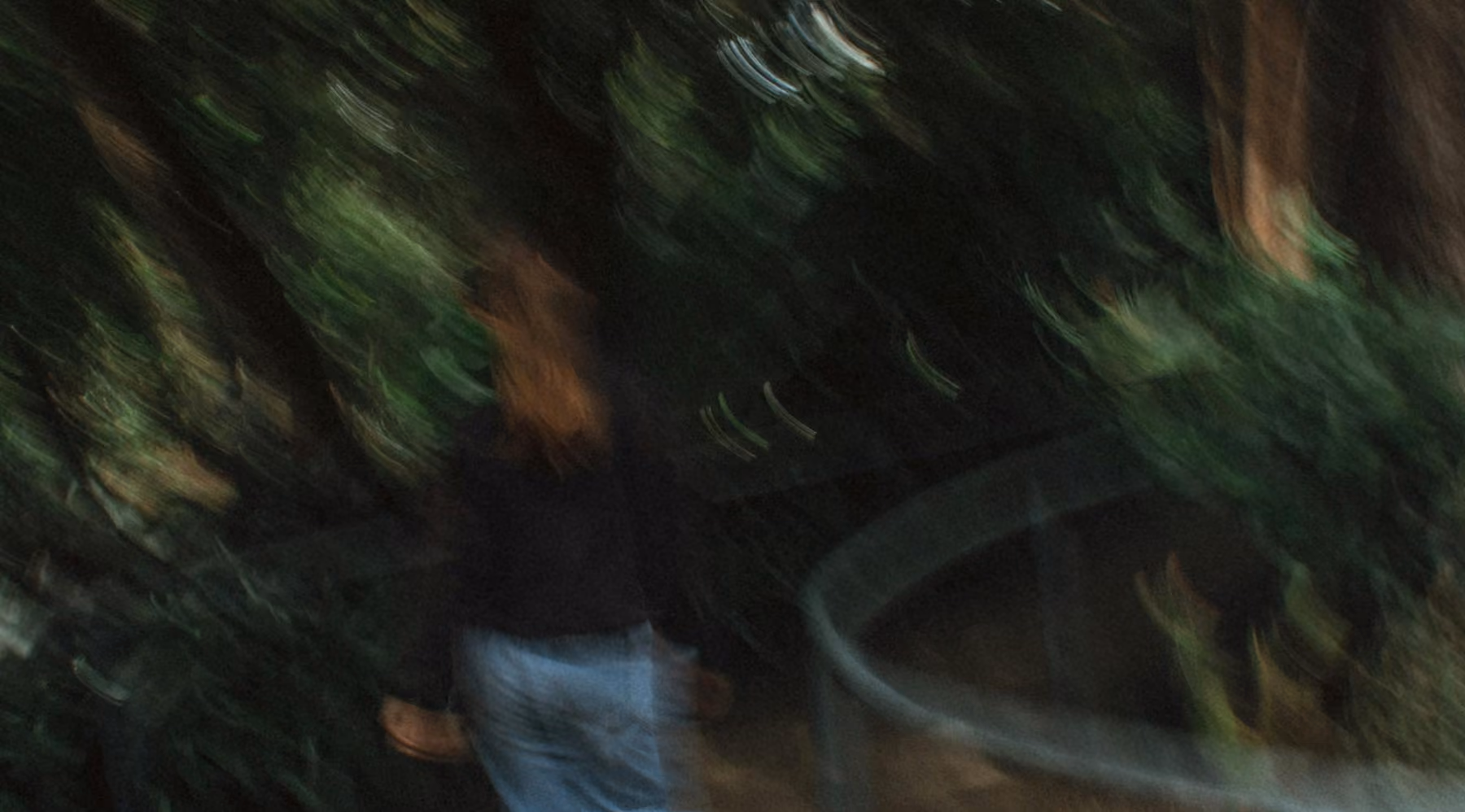 Lady walking through bushland blurred