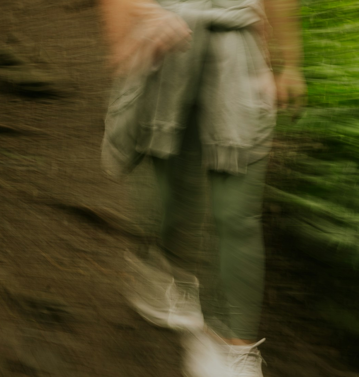person walking in bushland blurry