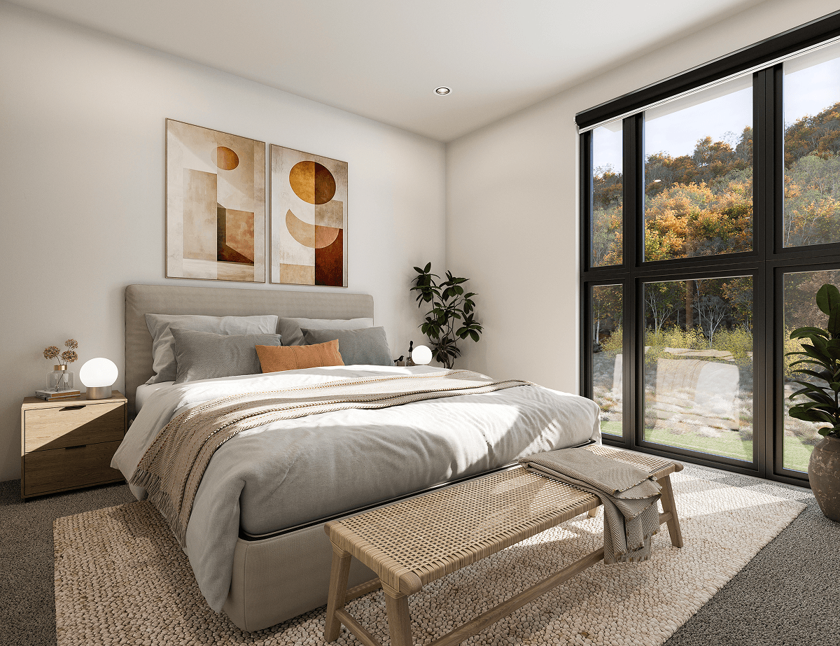 Bright bedroom with large windows, beige bed with pillows, wooden bench, plants, and abstract wall art.