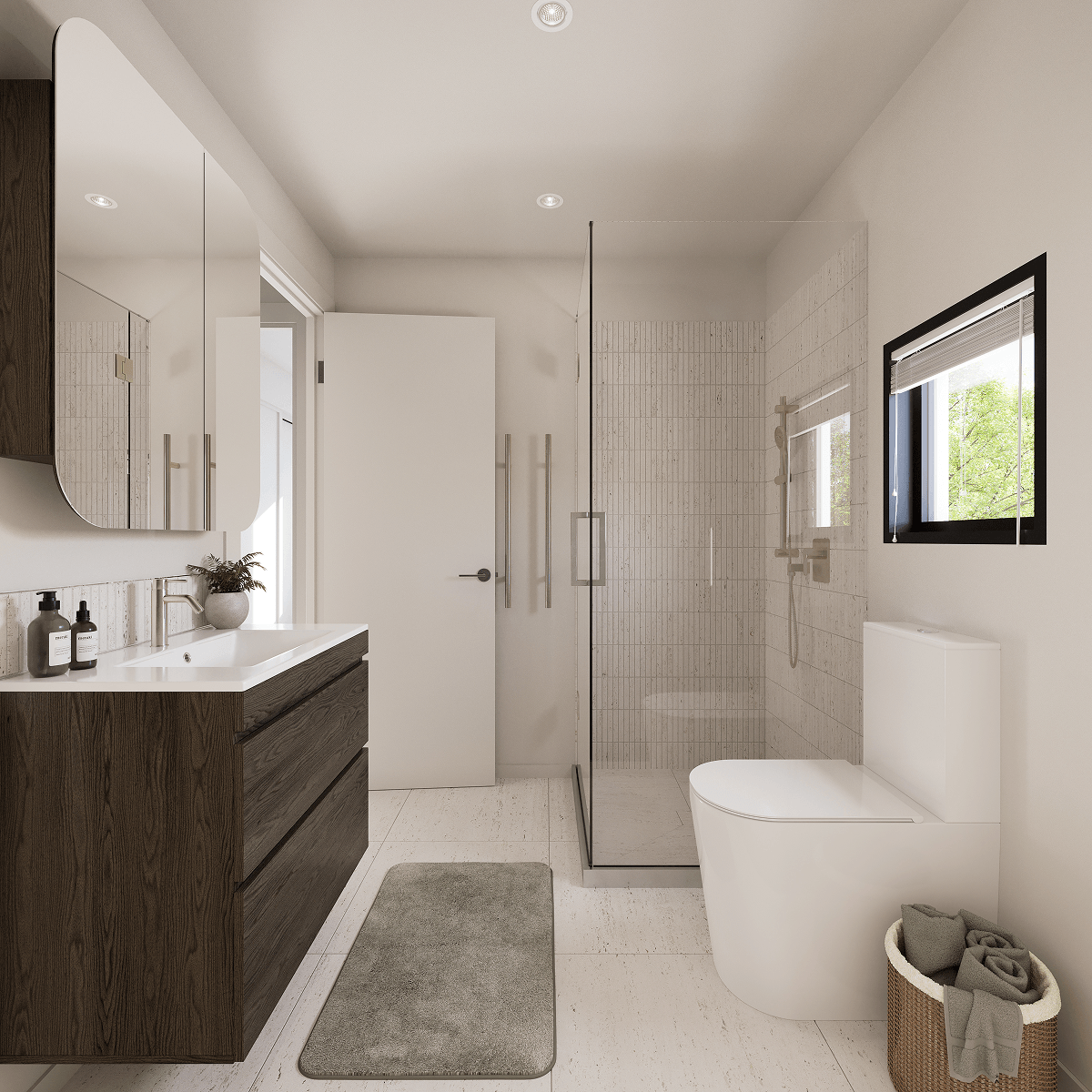 Modern bathroom with wood vanity, glass shower, toilet, window, and laundry basket with towels.