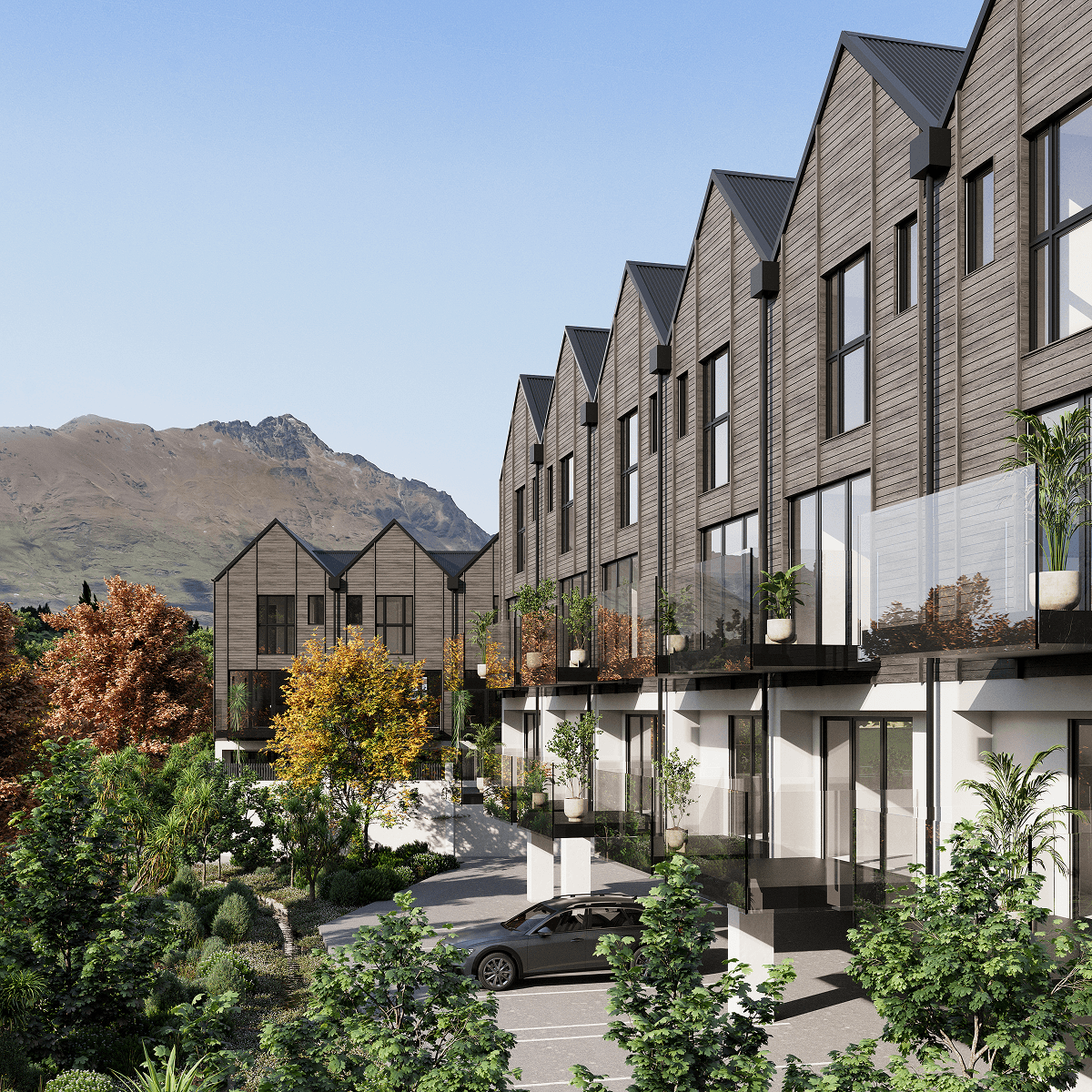 Modern row of brown wooden townhouses with large windows and glass balconies surrounded by trees and mountains.