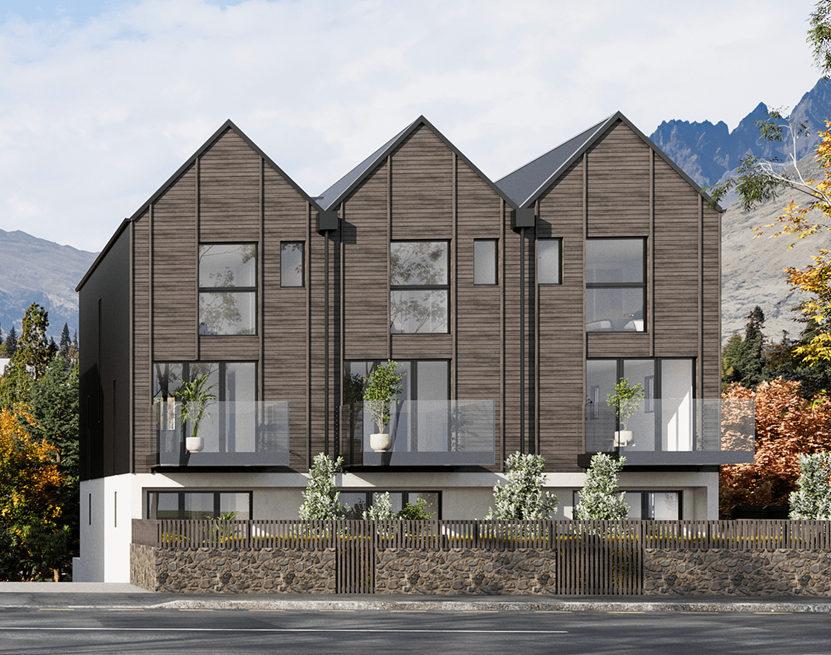 Modern three-story townhouse complex with dark wood siding and stone fence in front.