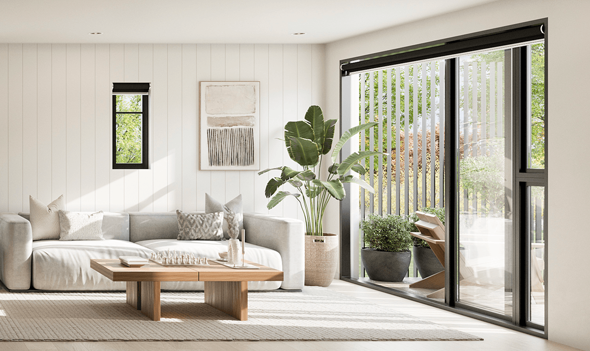 Bright living room with a beige sofa, wooden coffee table, potted plant, and large glass sliding doors.