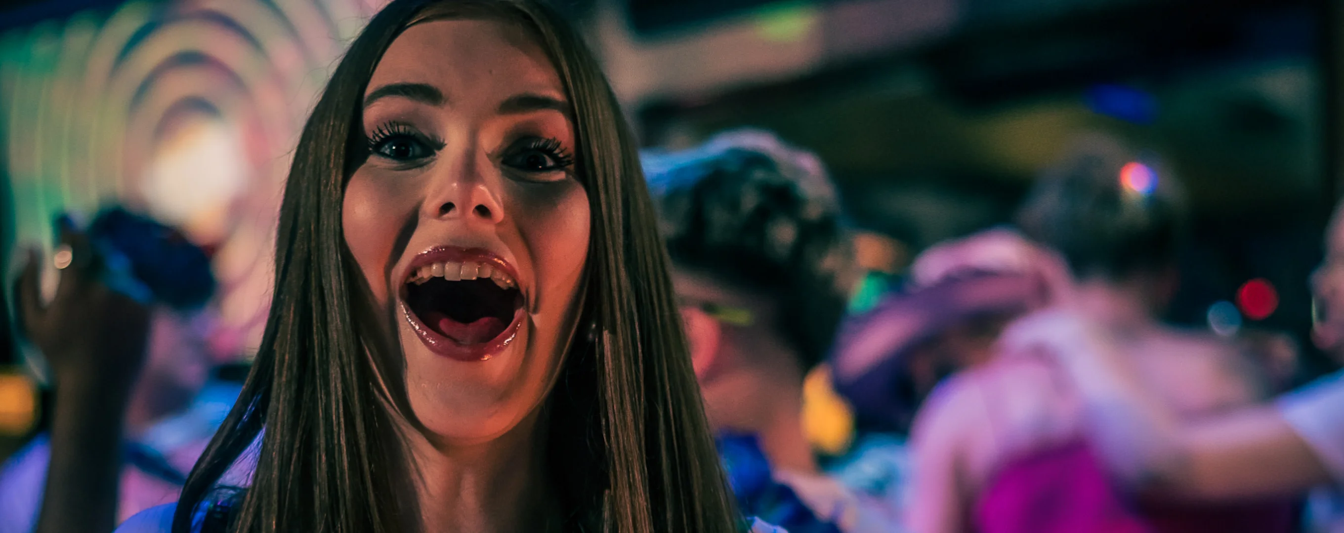 Woman dancing at a lively night festival event.