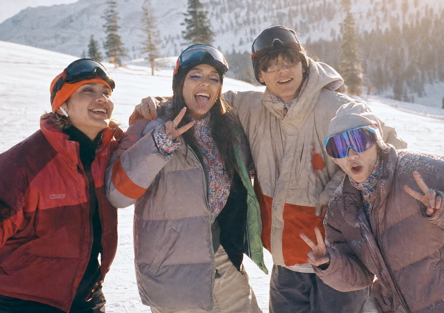 Friends playing together in the snow on a ski trip.
