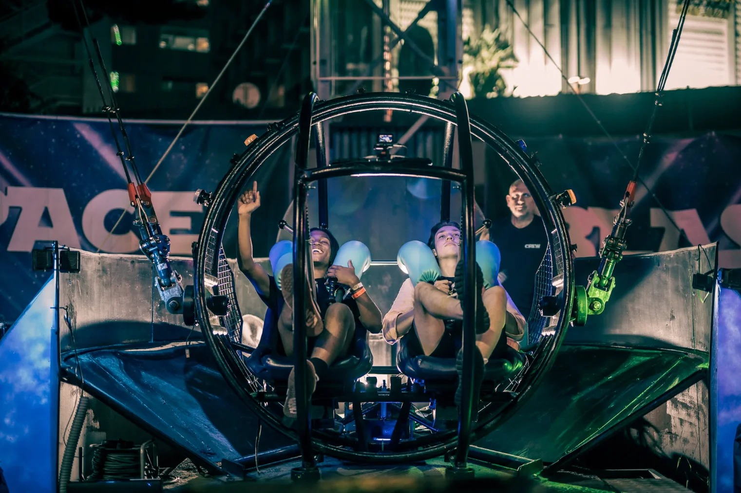 Group of friends riding a space-themed simulator attraction together.