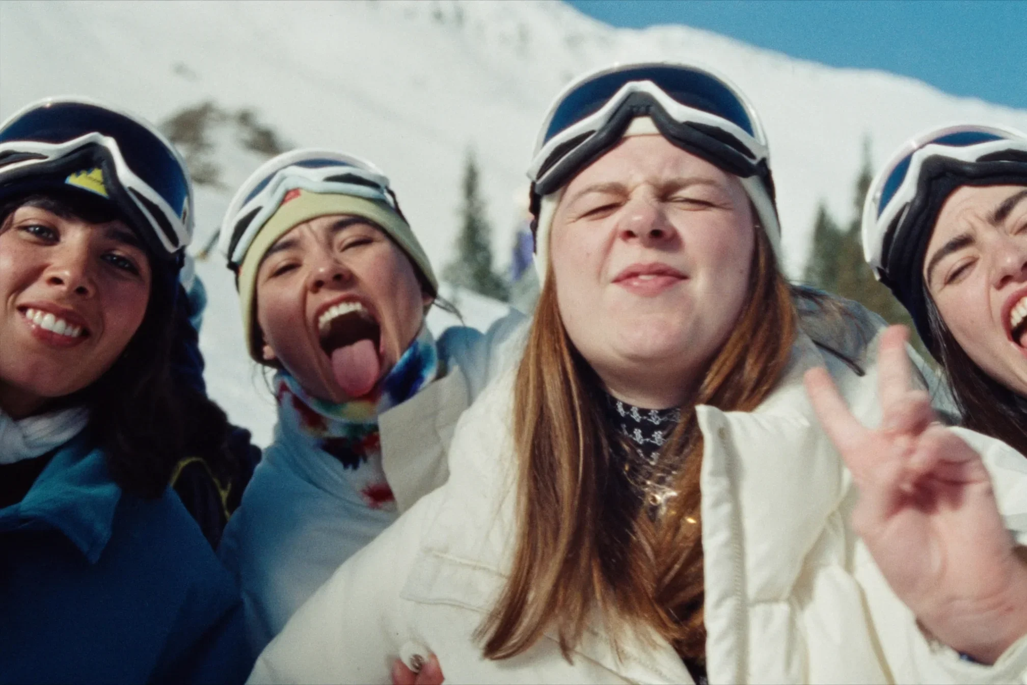 Friends sharing a fun moment while skiing together in the mountains.