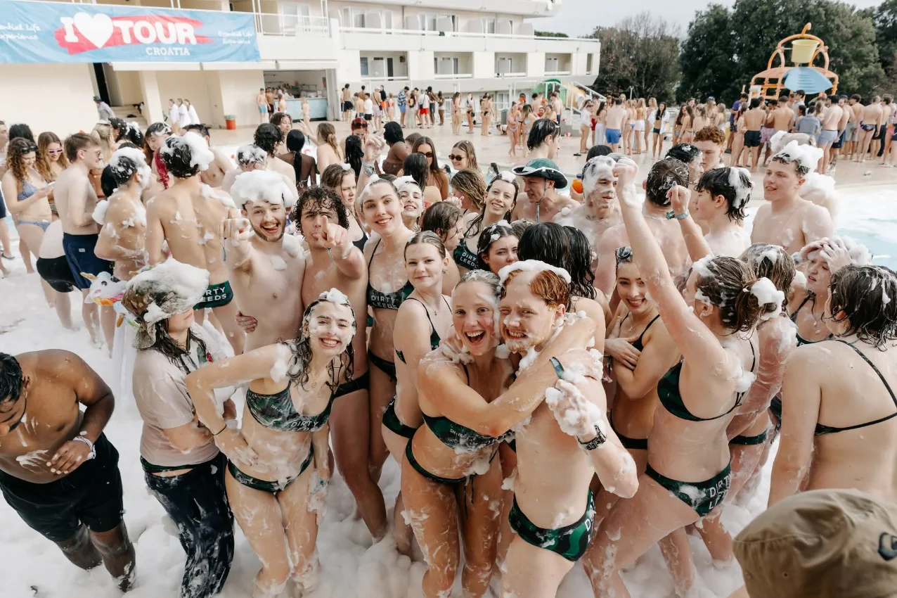 Crowd enjoying a foam bath party in Croatia at a festival event.
