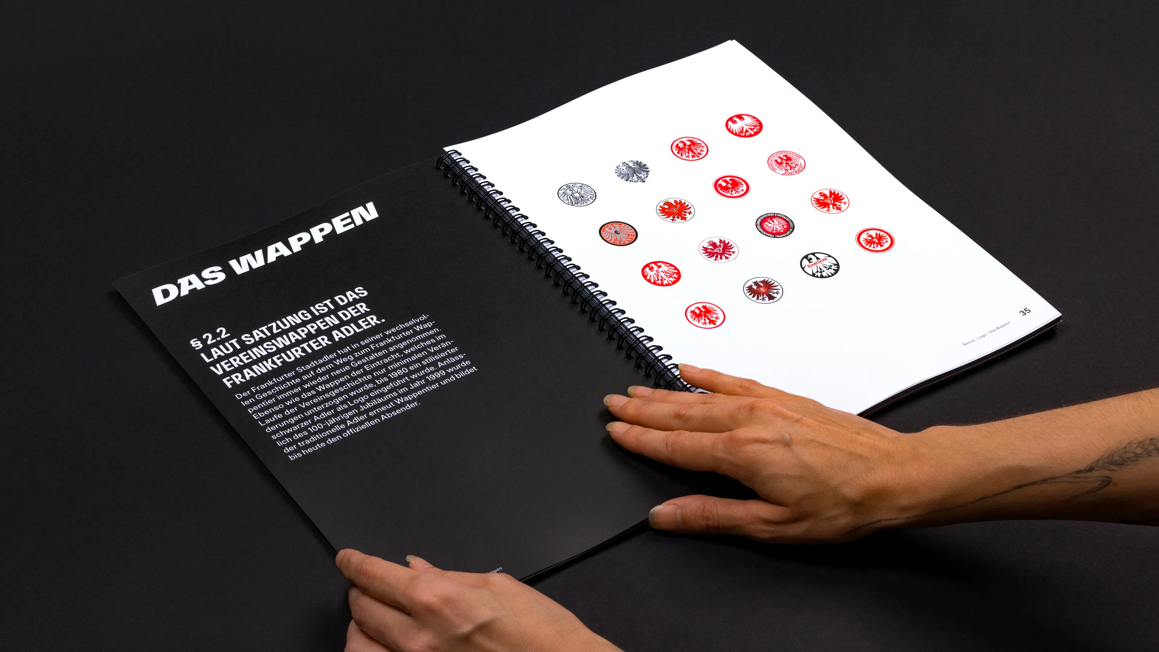 Eintracht Frankfurt Brandbook Wappen Doppelseite. Auf den Seiten wird die Wappenentwicklung über die Jahre gezeigt.