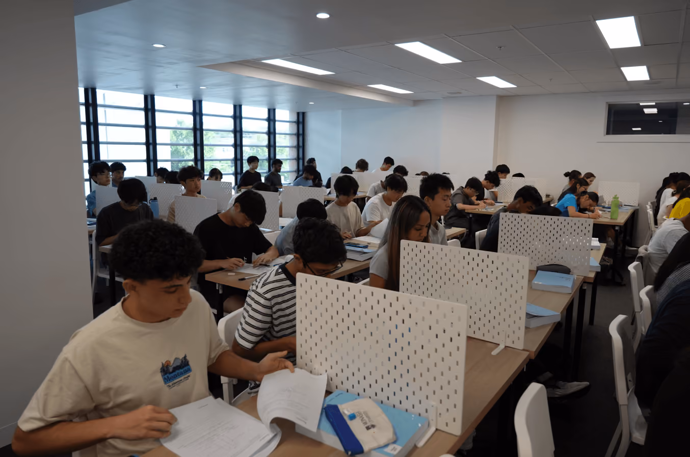 A detailed EdAtlas program image showing students completing a timed VCE practice exam, providing visual context for the surrounding educational content.
