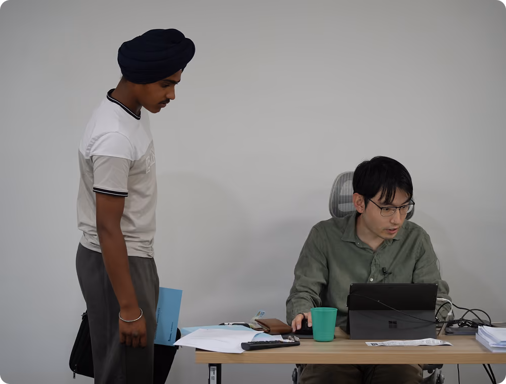 A professionally framed portrait showing tutor providing one-on-one support to a student, presented as part of EdAtlas student, tutor or program storytelling content.