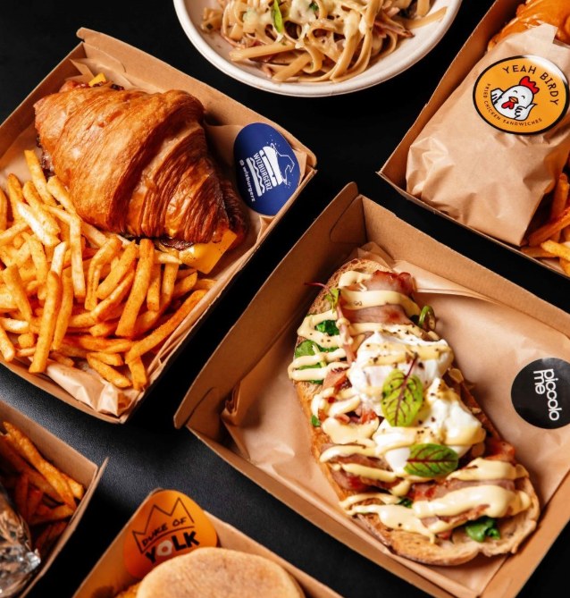 Delivery boxes from Go Dark's virtual brands: a croissant burger with fries, loaded toast and pasta