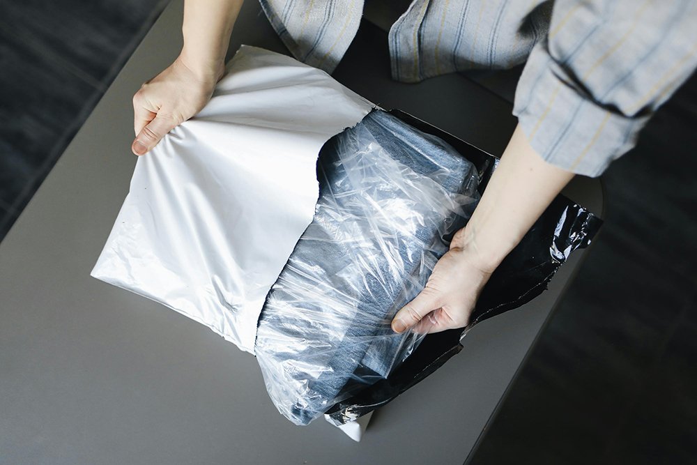 woman unpacking a pair of jeans