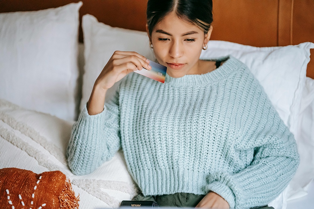 young woman holding a credit card