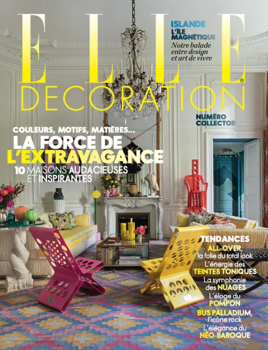 The cover of *Elle Décoration*, showing a Haussmann-style living room beneath a crystal chandelier, with pink and yellow designer chairs on a colourful rug.