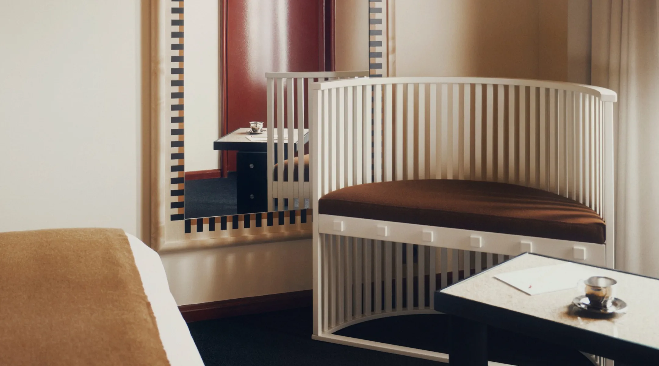 Fauteuil à barreaux blancs et miroir en damier, bonnes adresses de l'Hôtel Luxia à Montmartre