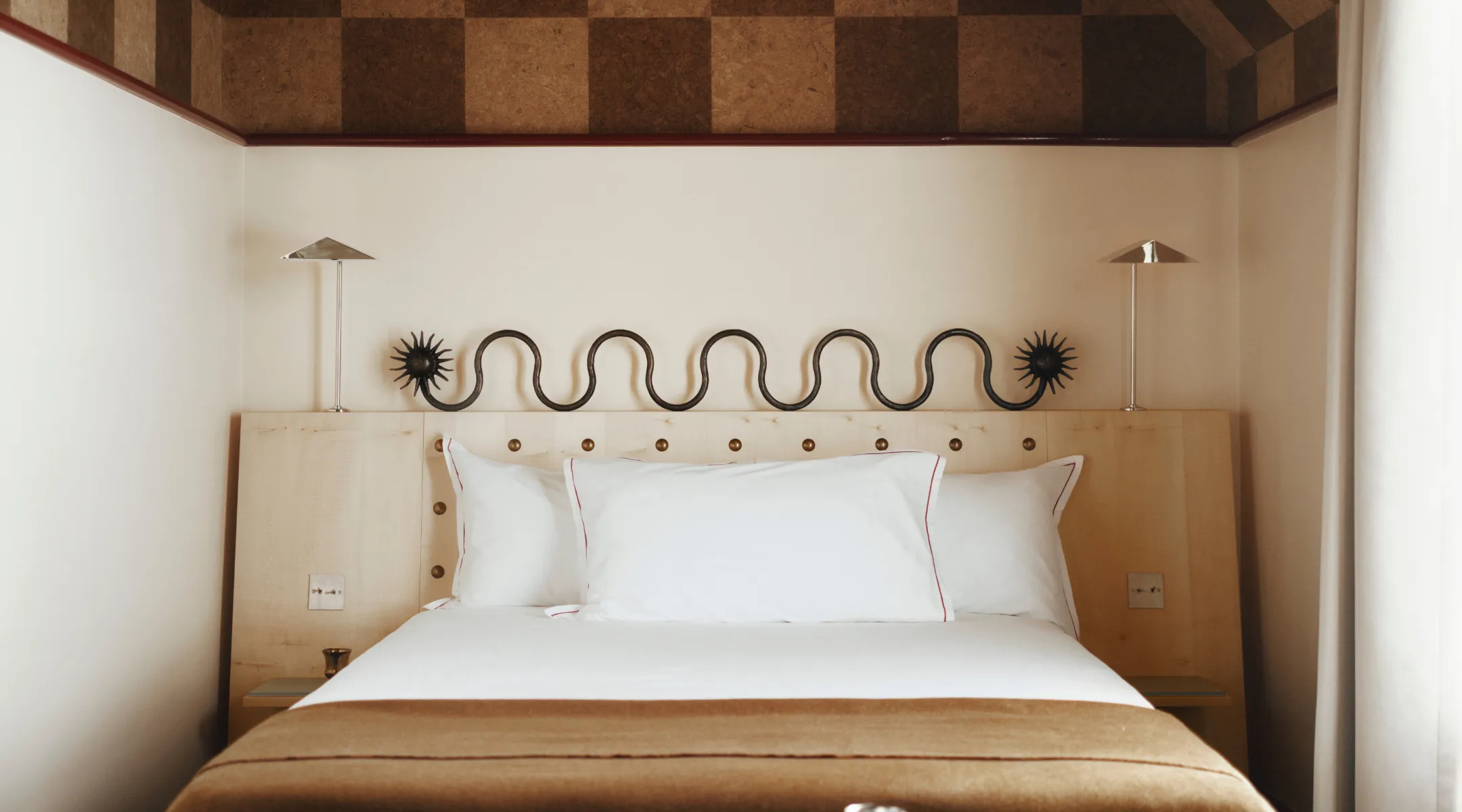 Hotel Luxia photo gallery in Montmartre: room with a white bed, wavy metal frieze and checkerboard cork ceiling