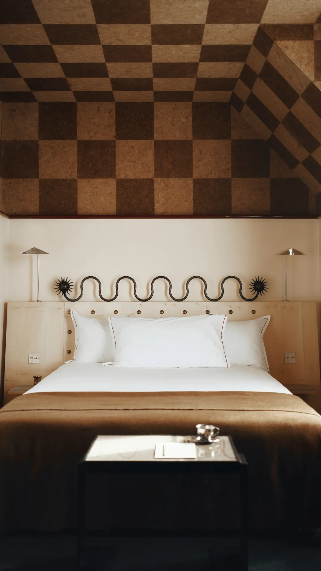 Hotel Luxia photo gallery in Montmartre: bed facing a low table beneath a checkerboard cork ceiling
