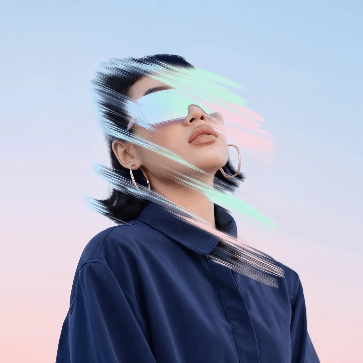 Woman in blue shirt wearing reflective futuristic glasses with colorful streak effects on face.