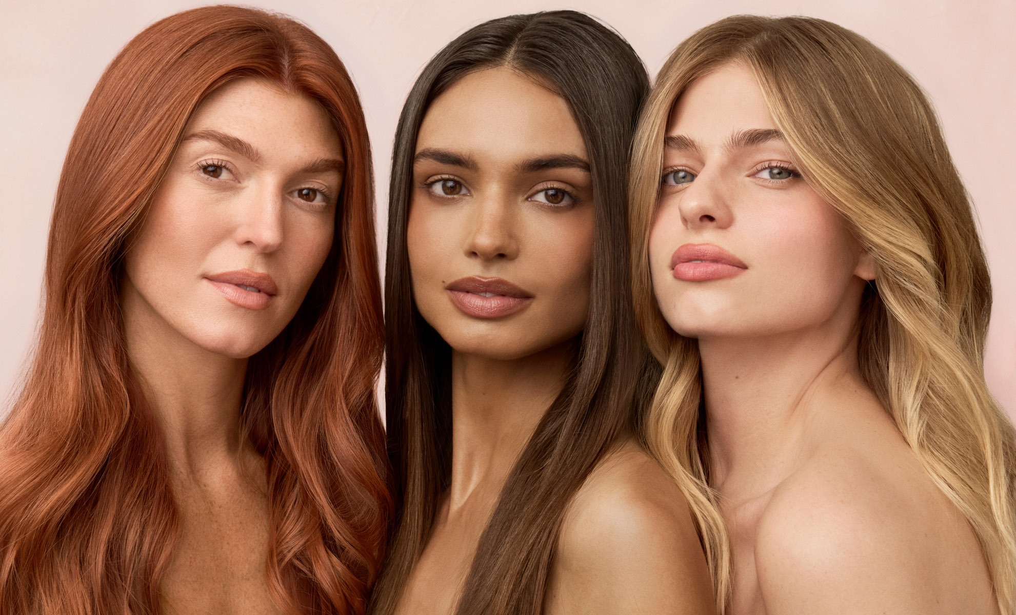 Three models with red, brown and blonde hair posing together