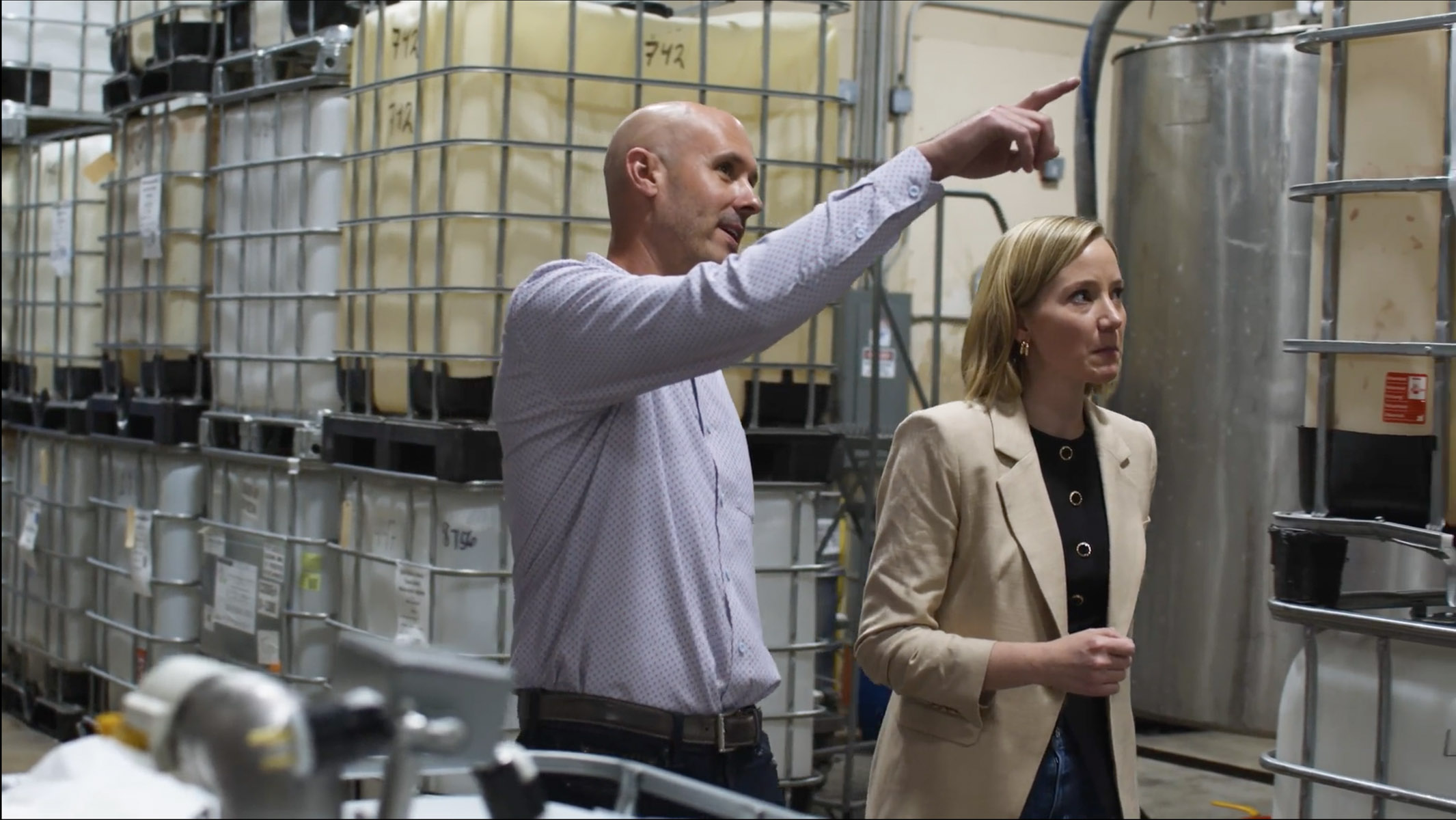 Two Creative Beauty Brands team members inspecting ingredient totes in the warehouse