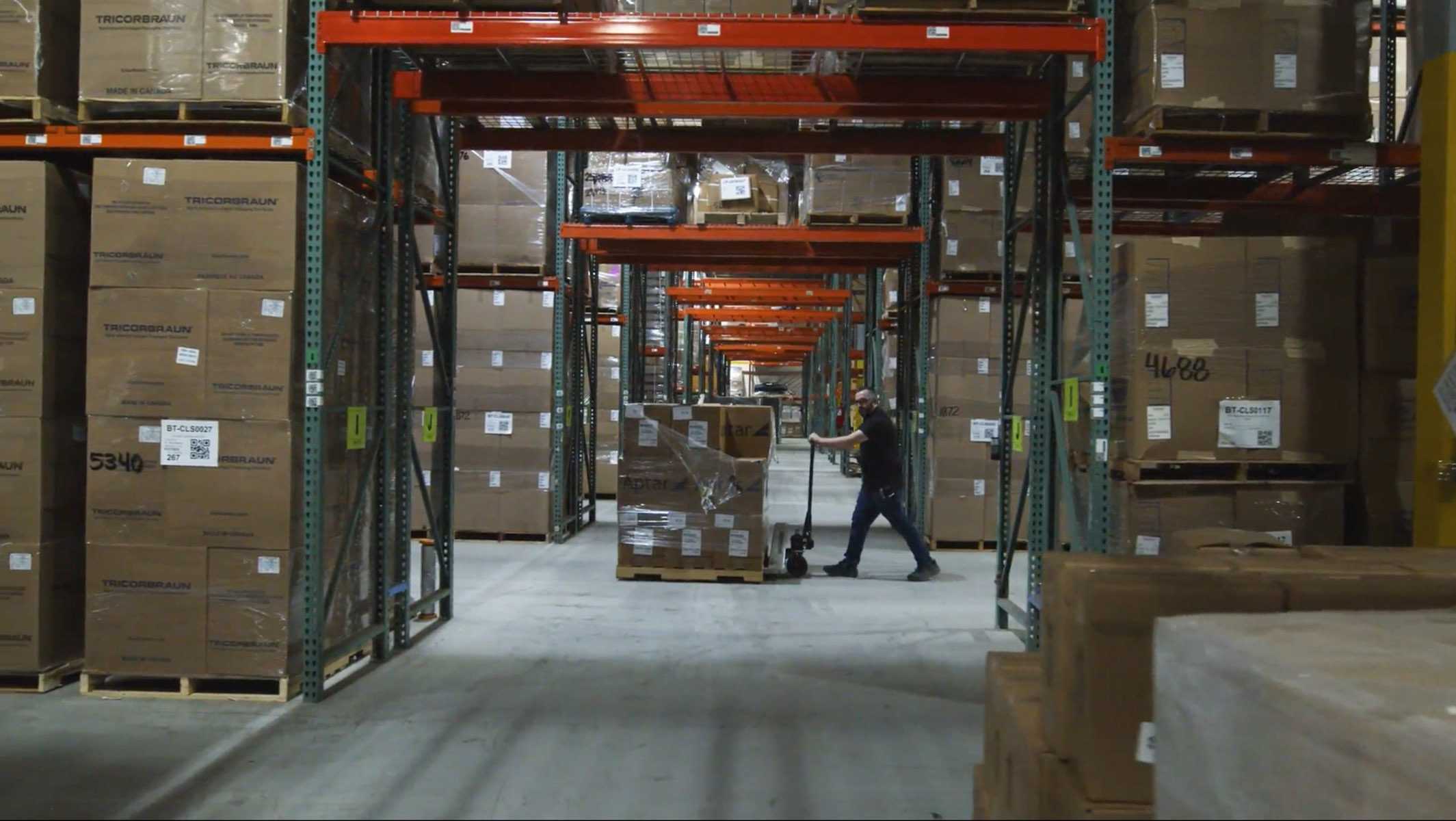 Worker moving a pallet through the Creative Beauty Brands distribution warehouse