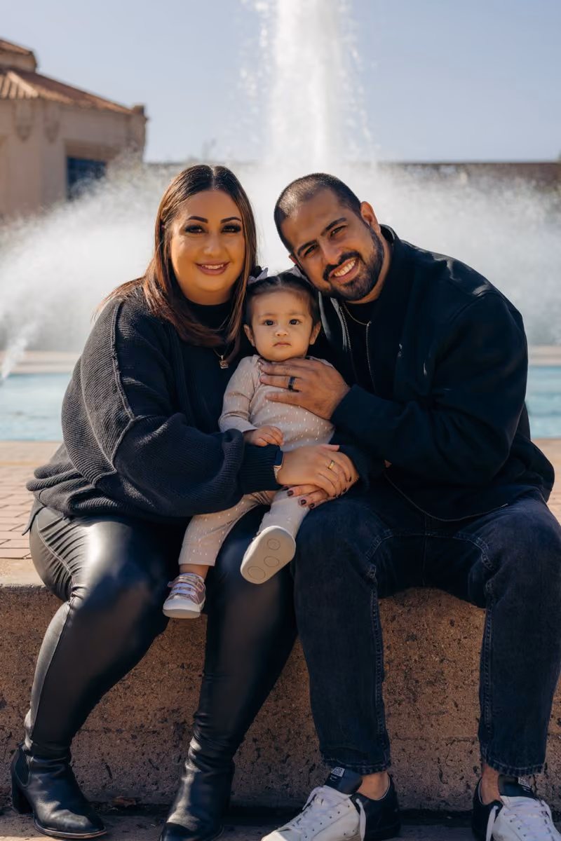 A family from Love Church gathered at an outdoor fountain in San Diego