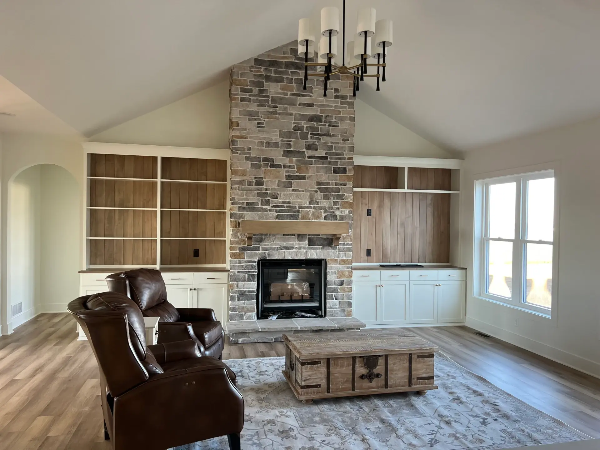living space with shelves built in with fireplace