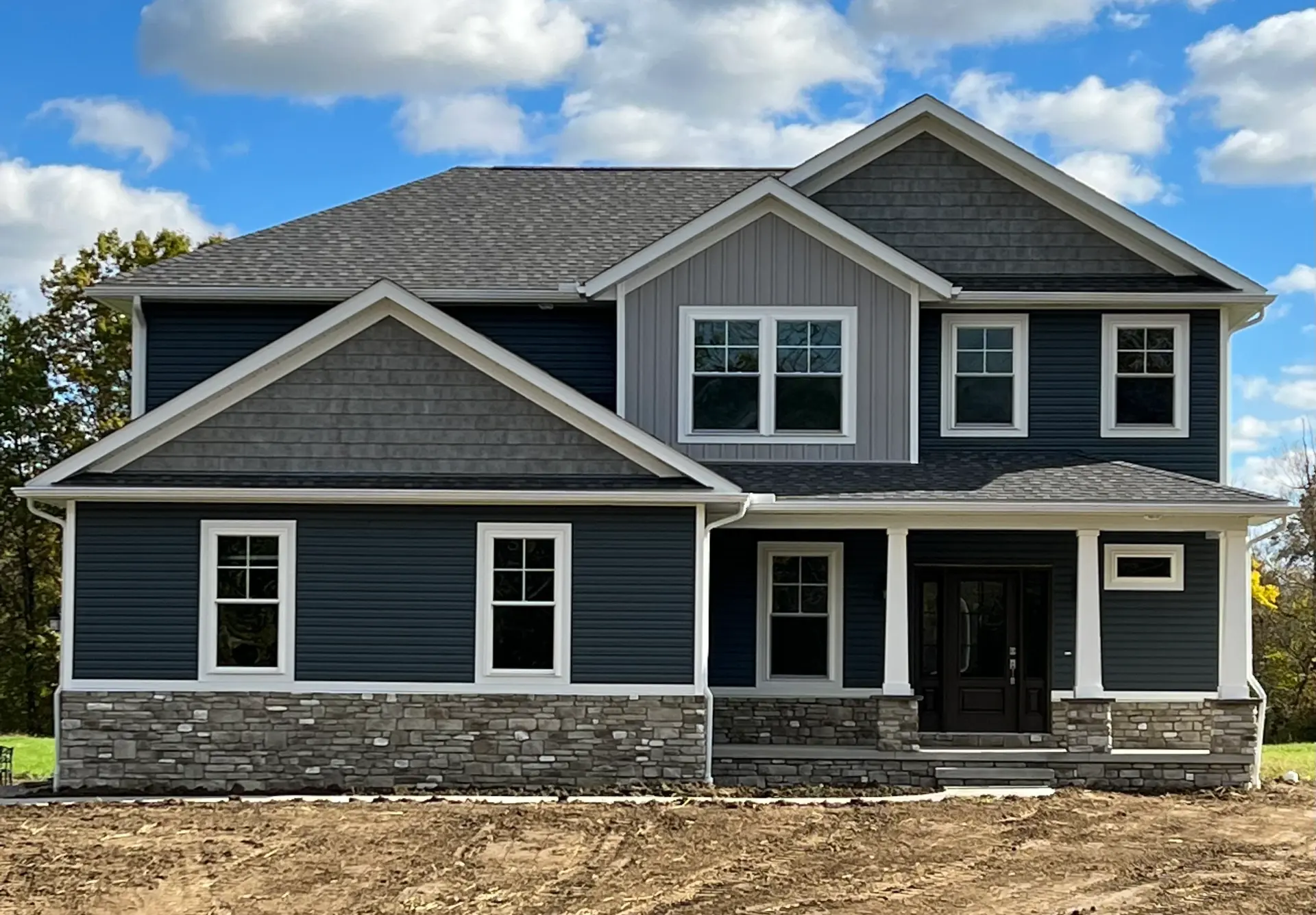blue vinyl siding two story home