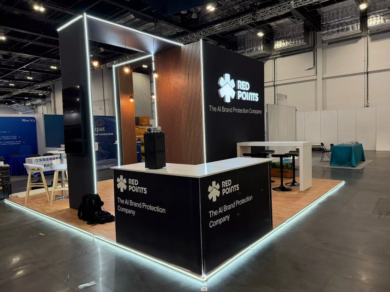 Custom exhibition stand design for Red Points with LED lighting and timber slat panelling