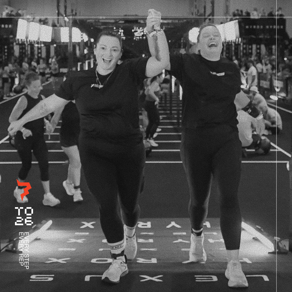 Two women smiling and jumping