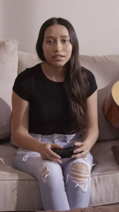 A young woman playing video games.