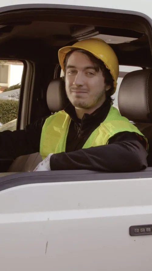 A truck driver sitting in his truck.