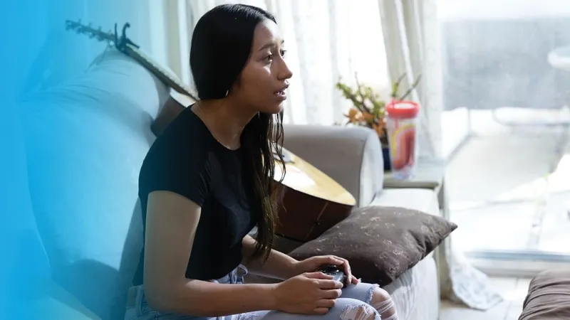 A young woman playing a video game, controller in hand