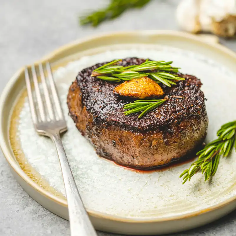 Filet mignon topped with garlic and rosemary