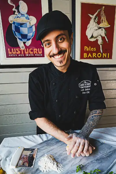 Cook Street chef kneading pasta dough