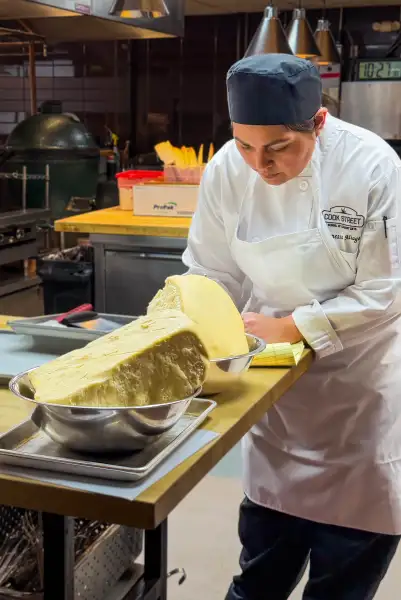 Cook Street student shaping bread dough