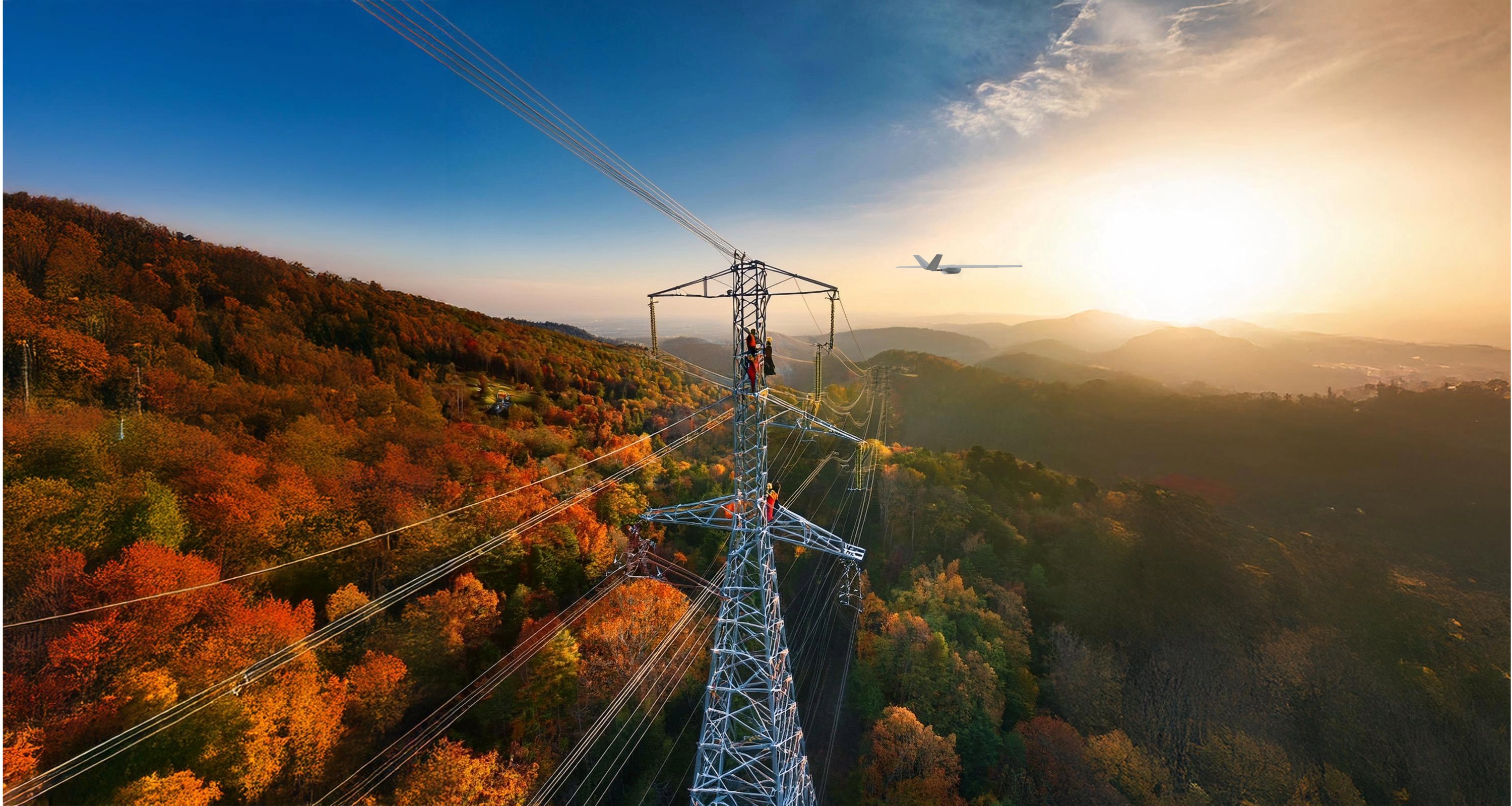 Workers in safety gear inspecting a tall power transmission tower amid autumn forest at sunset.