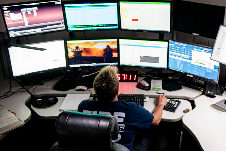 Marian Nevin, 788th Civil Engineer Fire Department dispatcher, works at her station inside the control and dispatch room of Station 1, June 23, 2021, at Wright-Patterson Air Force Base, Ohio. The fire department is on call 24/7 all year and capable of responding anywhere on base within 5 minutes when a call for help comes in. (U.S. Air Force photo by Wesley Farnsworth)