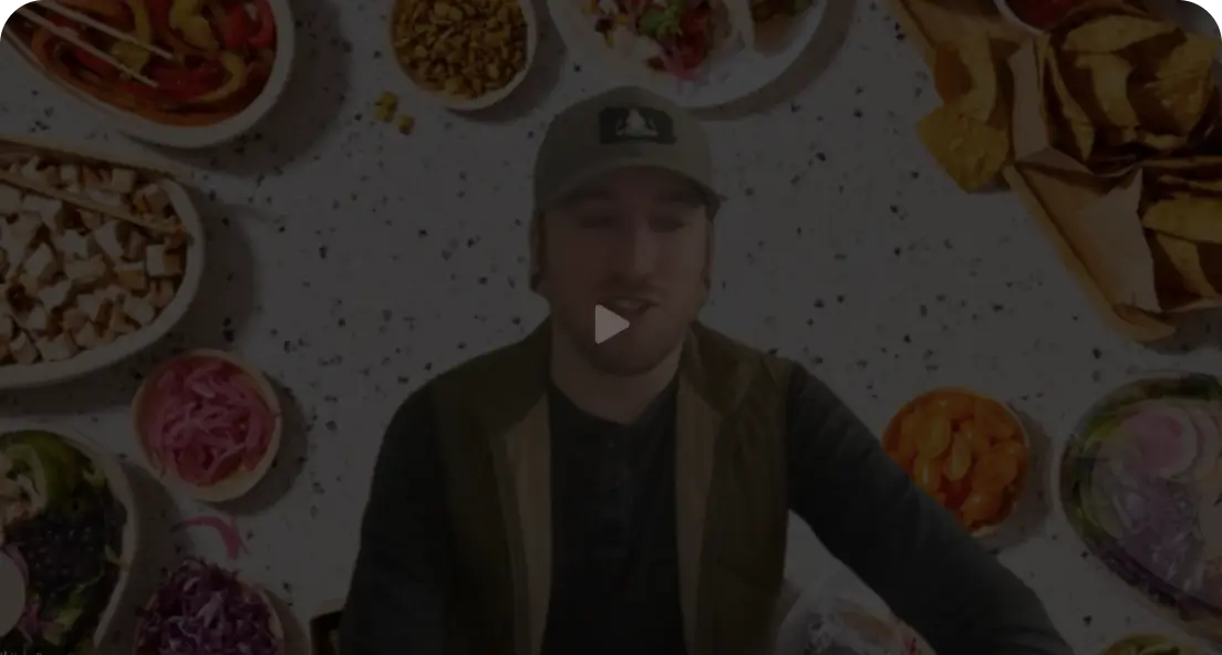a man standing in front of a table full of food