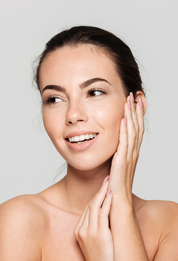 Woman smiling with her hand on her face