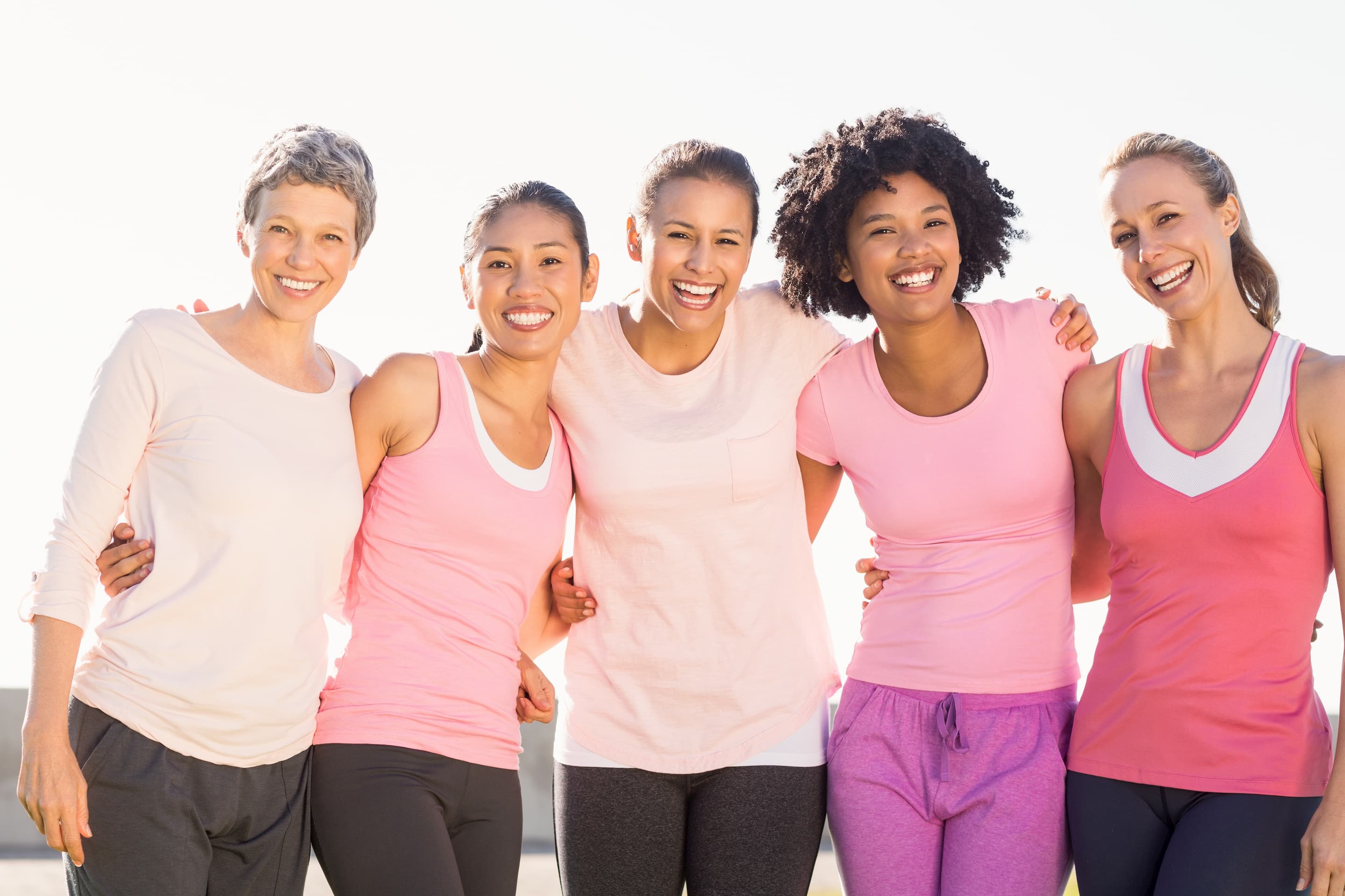 5 women standing by each other smiling