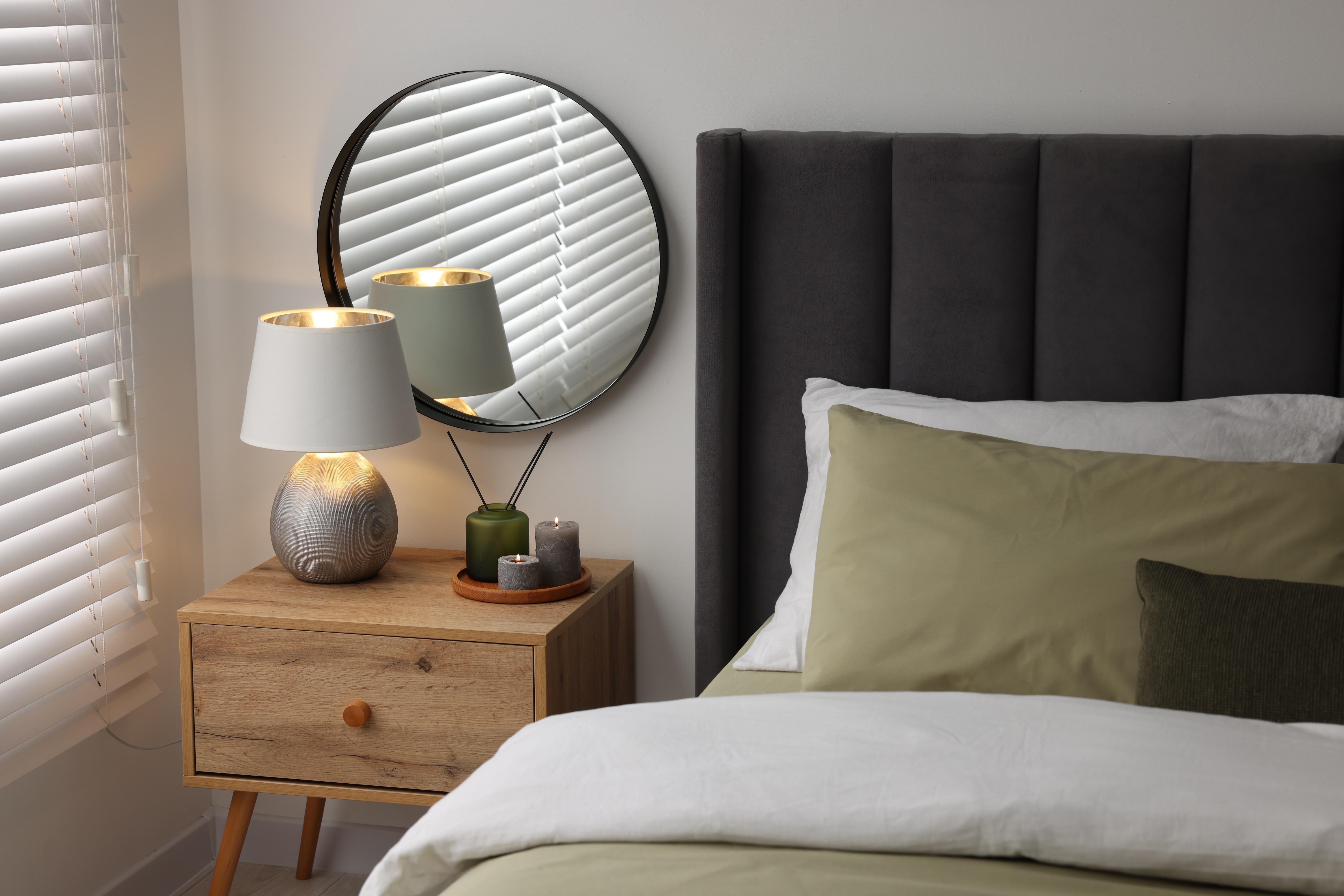 Bedroom staged bedding with nightstand stock image