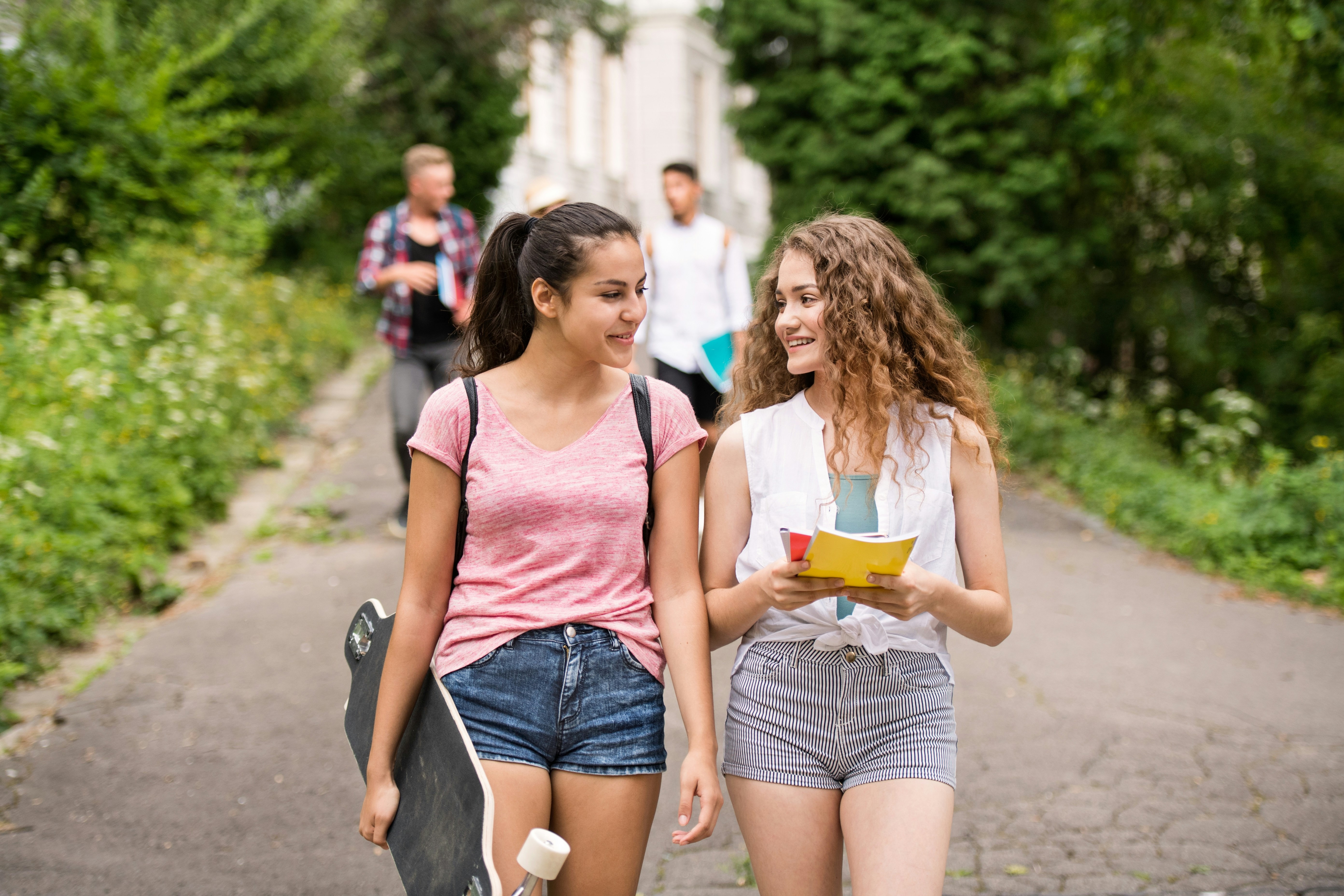 People walking down sidewalk stock image