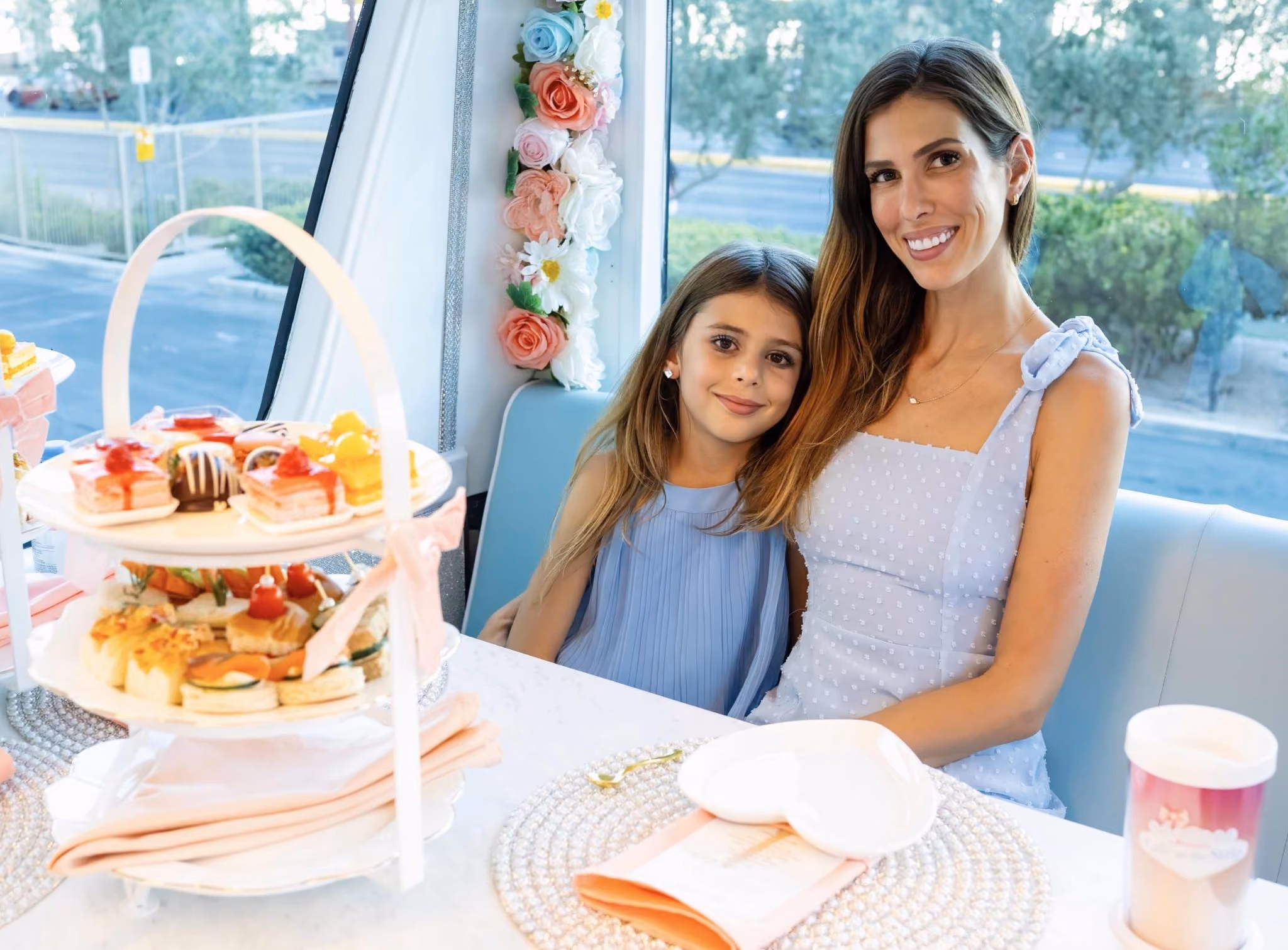Mother and daughter sharing high tea aboard the coach